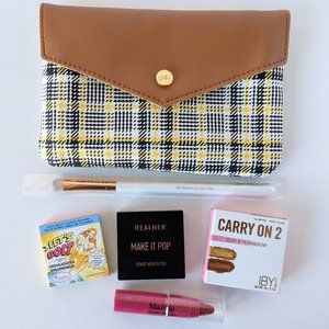 Yellow and black plaid IPSY bag with assorted makeup